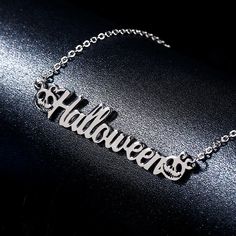 Surprise your loved one with a personalized gift. This classic name pendant can come with yours or your loved one's name. This necklace features two cute skull pumpkins connecting at both ends of the name, which is designed to be so lovely and super-cute. That make this name necklace truly interesting.Chain Type: O-chainMaterial: 925 SilverPlating Color: Silver, Yellow Gold, Rose Gold Halloween Engraved Metal Necklace, Halloween Gift Metal Necklace, Silver Nameplate Necklace With Charms, Personalized Themed Sterling Silver Necklace, Custom Name Themed Jewelry For Gifts, Custom Name Themed Jewelry Gift, Themed Custom Name Jewelry For Gifts, Themed Stainless Steel Jewelry As Gift, Engraved Necklaces For Halloween Gifts