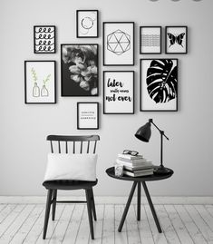 a chair and table in front of a wall with pictures on it