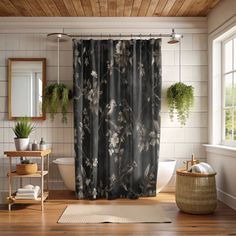 a bathroom with a shower curtain that has flowers on it and plants in the window