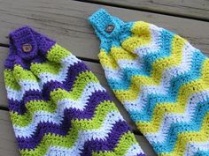 two crocheted hats sitting on top of a wooden table next to each other