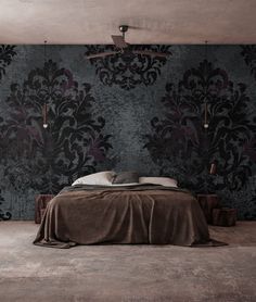 a bed sitting in the middle of a bedroom next to a wallpapered wall