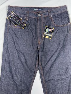 Elevate your denim game with these vintage Jinzu JZ men's jeans. The relaxed fit and high-rise waist make them perfect for any occasion, while the solid blue color and denim fabric wash give them a classic 90s look. The zipper closure and baggy style add to the overall aesthetic, making them a must-have for any fashion-forward man's wardrobe. These jeans are made of a comfortable blend of polyester and cotton, ensuring they are durable and easy to care for. With a waist size of 36 inches and inseam of 32 inches, they are a great fit for men of all shapes and sizes. Don't miss out on these JNCO skater jeans that are sure to turn heads. See small imperfection pictured. Baggy Style Men, 90s Baggy Style, Grunge Cross, 90s Baggy, Skater Jeans, Baggy Style, 90s Looks, Fit For Men, Men's Wardrobe