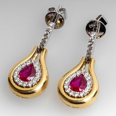 These lovely ruby dangle earrings each feature a pear cut ruby in a four-prong setting. The rubies are each surrounded by a halo, scallop set with fifteen (15) round brilliant cut diamonds. The center is surrounded by a plain, bright polished yellow gold halo. The white gold top of the earring is scallop set with six (6) round brilliant cut diamonds. The earrings measure 21.2mm long by 10.0mm wide, finished with posts and friction nut backs. Signed Spark. The matching necklace is sku AD17754. Elegant Pear-shaped Ruby Jewelry, Formal Pear-shaped Ruby Jewelry, Elegant Ruby Earrings With Halo Setting, Sparkly Things, Gold Halo, Ruby Earrings, Gold Top, Butterfly Earrings, Matching Necklaces