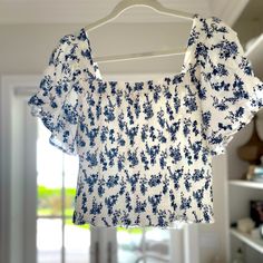 Nwt! Beautiful Medium Length Smocked Top In White And Navy Blue Floral Pattern With Flowy Sleeves! About 13.5/14” In Length Spring Vacation Smocked Top With Square Neck, Casual Floral Print Smocked Top With Square Neck, Casual Floral Print Square Neck Smocked Top, Vacation Smocked Top With Square Neck, Floral Print Smocked Top For Brunch, Floral Print Smocked Top With Short Sleeves For Brunch, Floral Print Short Sleeve Smocked Top For Brunch, Casual Smocked Top With Square Neck For Brunch, Floral Print Square Neck Top For Beach