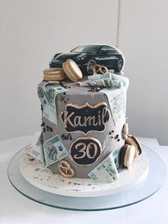 a birthday cake decorated with cars and money