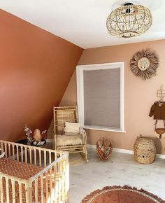 a baby's room with orange walls and furniture