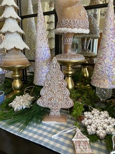 a table topped with lots of different types of christmas trees