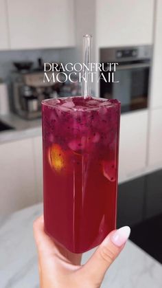 a person holding up a drink in their hand with the caption dragonfruit mochai