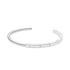 Streamline your look with the Pandora Signature ID Bangle. With a half-squared, half-rounded profile, this bangle is hand-finished in sterling silver. The round polished profile transitions to a larger squared profile in the middle, which features the Pandora logo on its three outer sides. Each end of the bangle includes the Pandora Crown O monogram. The bangle is precisely sized for optimal performance and fit and is not designed to be flexed and twisted when put on and removed. O Monogram, Pandora Logo, Silver Bangle Bracelet, Sterling Silver Bangle, Silver Bangle, Pandora Jewelry, Pandora Charms, Bangle Bracelet, Cuff Bracelets