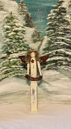 a painting of a person standing on top of a snow covered hill with trees in the background