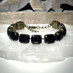 Dare to get noticed in our bold crystal line bracelet. Featuring a sultry row of onyx black 12x10mm luxury European crystals, this piece sparkles with an understated elegance. While it's certainly able to stand on it's own, you'll find it effortlessly layers with whatever you may choose to pair it with.  Our bracelets are adjustable from 7.25 to 8.25 inches so that you get a truly custom fit. This listing is for one single strand bracelet.  Rew Elliott...Timeless, Tasteful, Treasured.  See more gorgeous treasures from Rew Elliott here: http://www.etsy.com/shop/rewelliott All Rew Elliott pieces are handmade in the U.S.A. and are nickel free. Every brilliant stone is hand set with care and precision. Jewelry Care  As a general rule, your jewelry should be the last thing you put on in the mor Pearl Bar Necklace, Crystal Ball Necklace, Bracelet Luxury, Bracelet Tennis, Ball Necklace, Strand Bracelet, Understated Elegance, Crystal Pearls, Brass Chain