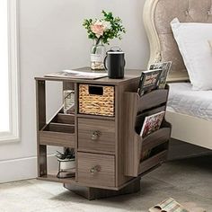 a bedroom with a bed, nightstand and magazine rack on the floor next to it