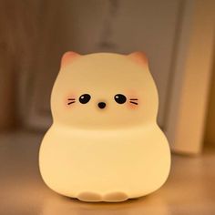 a white cat lamp sitting on top of a table