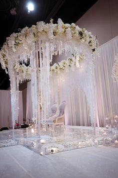 an elaborate wedding setup with white flowers and candles