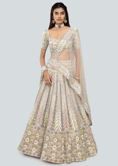 Alabaster applique and embellished heavy kali mirror work net lehenga with broad lehenga border, blouse and broad border net dupatta. Festive Embroidered Off White Lehenga, Festive Embroidered Off-white Lehenga, Bollywood Style Cream Choli With Cutdana, Designer Cream Choli With Cutdana Details, Cream Choli With Intricate Embroidery For Festivals, Bollywood Style Cream Lehenga For Festive Occasions, Off White Resham Embroidery Choli For Festivals, Cream Floor-length Sets With Sheer Dupatta, Semi-stitched Cream Lehenga With Cutdana