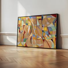 an abstract painting on the wall in a room with hard wood floors and white walls