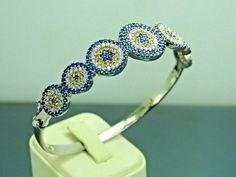 Material= 925 Sterling Silver Stone/Stones=Sapphire&Citrine&Zircon Style= Eastern Bangle Width (mm)=18x55 Wrist Diameter(mm)=56x60 Weight(gr)=10,9 Coating=None Item Specify=Evil Eye Design White Gold Multi-stone Round Bracelet, Cubic Zirconia Multi-stone Bangle, Multi-stone Cubic Zirconia Bangle, Sapphire Cubic Zirconia Bracelets, Silver Sapphire Bangle Jewelry, Silver Sapphire Bangle Bracelet, Sterling Silver Bracelet With Gemstones In White Gold, Sterling Silver Diamond Bracelet With Gemstone, Hand Set Sapphire Bracelet Jewelry