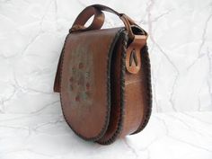 "Excellent opportunity to make a great gift. Unique vintage handbag with a single shoulder strap. Handmade of dark brown leather in Bulgaria in the 70s. It has one main compartment and a pocket inside. a smooth brown fabric. Decorative colored beads details. The details are intricate, attractive and feminine. The vintage vibe is a perfect way to turn any outfit into a unique fashion statement. The leather has preserved its sturdiness,, it is still in a very good condition, just add to its unique Handmade Vintage Brown Travel Bag, Vintage Brown Handmade Travel Bag, Vintage Hand Tooled Tote Satchel, Vintage Style Hand Tooled Tote Satchel, Vintage Hand-tooled Tote Satchel, Vintage Brown Bag With Adjustable Strap, Vintage Brown Shoulder Bag With Leather Handles, Vintage Tote Satchel As Gift, Vintage Handmade Shoulder Bag For Daily Use