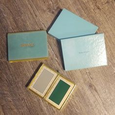 three different colored boxes sitting on top of a wooden table