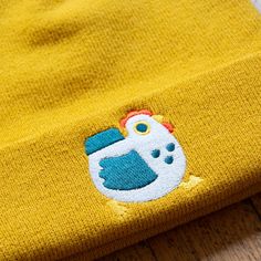 Chicky hat! A colorful Americana chicken on a lovely mustard yellow hat, now with feet! Hats are 100% acrylic and one-size fits all. Big and comfy! Fits nicely on a human head. Designed in Minneapolis and manufactured in China. Yellow Cotton Beanie Hat, Playful Yellow Beanie Hat, Playful Yellow Cotton Hats, Americana Chickens, Embroidered Chicken, Sticky Note Planner, Celebration Balloons, Yellow Hat, Human Head