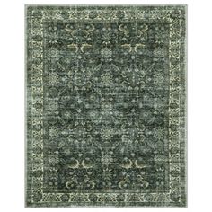 a green rug with an ornate design on the top and bottom, in grey tones