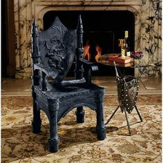 a chair sitting in front of a fire place next to a table with a wine bottle on it