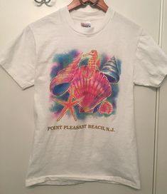 Vintage Point Pleasant Beach Pastel Shell Seahorse Tee. Has a slightly puffy look to the print! Excellent vintage condition, please see all photos. Ships with USPS. Vintage Printed T-shirt For Vacation, Multicolor Vintage Print T-shirt, Vintage Graphic Print Beach T-shirt, Vintage Graphic Print T-shirt For Beach, 90s Cotton T-shirt For Beach, 90s Cotton T-shirt For The Beach, 90s Style Cotton T-shirt For Beach, Vintage Screen Print T-shirt For Beach Season, Vintage Graphic Print T-shirt For Beach Season