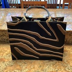 Brand New Chico's Animal Print Tote Black And Brown $139 Measures 14w X 10h (Without Handle) X 7d 20h With Handle Polyurethane Designer Brown Box Bag For Shopping, Brown Box Bag With Removable Pouch For Shopping, Brown Evening Box Bag, Chic Brown Tote Box Bag, Brown Box Bag With Top Carry Handle For Shopping, Brown Box Bag With Handles For Shopping, Chic Brown Box Bag With Leather Handles, Printed Purse, Tote Handbag