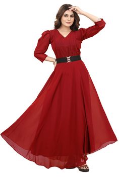 a woman in a red dress posing for the camera with her hands on her head