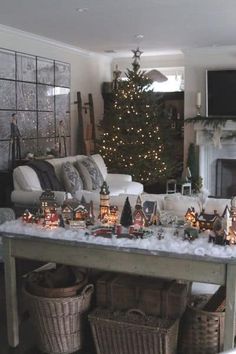 a living room filled with lots of furniture and a christmas tree in the back ground