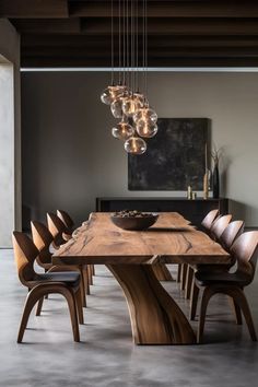 a wooden table with chairs and lights hanging from it