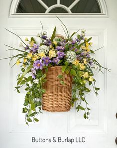 a basket filled with lots of flowers sitting on top of a white door sill