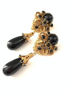 Gorgeous Vintage Haskell Style Black and Gold Filigree Crystal Clip On EarringsThese earrings feature a jet black cabochon and jet black rhinestones set in gold plated settings attached to filigree backs. The earrings are clip on. The black drop at the bottom is good quality lucite so the earrings aren't too heavy.they measure 2 7/8" x 1 1/8"Important: Please read all shop policies prior to purchase.The below is a brief overview, to view full shop policies please go to the homepage of the shop a Luxury Vintage Black Clip-on Earrings, Miriam Haskell, Gold Filigree, Earrings Wedding, Black Rhinestone, Clip Earrings, Bride Bridal, Color Shades, Bridal Earrings