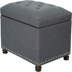 a gray ottoman with studded legs and buttons on the bottom, in front of a white background