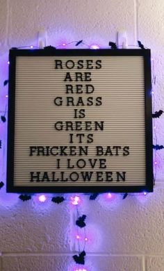 a sign on the wall that says roses are red, grass is green, broken bats i love halloween