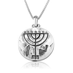 Unique silver pendant in a round shape with a menorah shape engraved in the center. Size in inches: 0.9 x 0.7 x 0.05. The Menorah is both a symbol of Hanukkah, as well as a vessel in the Holy Temple in Jerusalem, lit daily by the high priest. After the destruction of the second temple by the Roman Empire, the Menorah was believed to be taken by the Romans, as documented on the Arch of Titus in Rome. 925 Sterling Silver Chain. White gift box. Engraved Sterling Silver Star Of David Necklace, Round Etched Necklaces For Commemoration, Etched Round Necklaces For Commemoration, Etched Necklaces For Commemoration, Hanukkah Sterling Silver Silver Necklace, Silver Sterling Silver Necklace For Hanukkah, Arch Of Titus, Friendship Rings, Silver Engraving