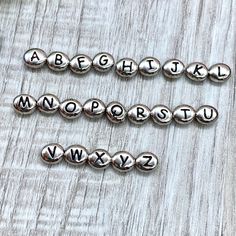 Personalize it with Silver pewter stamped alphabet letter beads. Baby bracelets, XO love necklaces or bracelets, couple bracelets, etc. The ideas are endless.  Silver pewter stamped oval alphabet beads are perfect alone or pared with gemstones or any other beads.  This listing is for (1) one pack of silver pewter, oval alphabet letter beads 6mm x 7mm as listed at checkout. If you have any questions, please inquire prior to checkout.   **Please choose letters available at checkout as listed. DETAILS SIZE: 6x7mm SHAPE: oval COLOR: Silver pewter with black stamped letter **I do my best to capture the actual color and beauty of each item, however, colors can vary slightly due to lighting. ** **Colors may vary slightly also due to monitor settings and/or resolution. ** If you have purchased mor Silver Jewelry With Letter Beads, Personalized Round Beads Charms As Gifts, Personalized Beads Charms For Gifts, Personalized Round Beads Charms For Gift, Silver Letter Beads Charms For Gifts, Silver Letter Beads Jewelry For Personalized Gift, Personalized Silver Jewelry With Letter Beads, Personalized Silver Bracelet With Letter Beads, Bracelets Couple