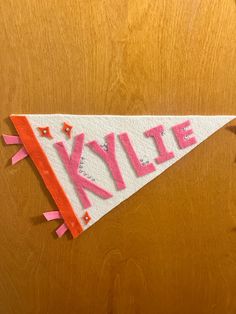 a white and red kite with the word kylie written on it's side