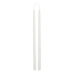 two white candles sitting next to each other