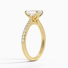 a yellow gold engagement ring with diamonds on it