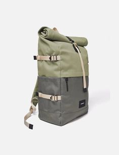 a backpack that is sitting on top of a white surface and has two straps around it