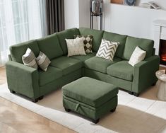 a living room with a green couch and ottoman