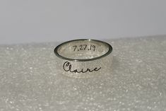 a close up of a ring with the word cause written on it, sitting on a white surface