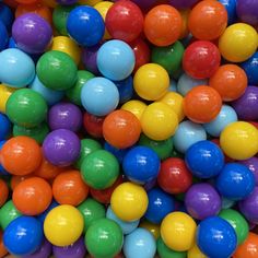 there are many different colored balls in the ball pit