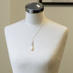 One of a kindHandmade in Seattle Unique long oval baroque pearl with smaller white and pale grey pearls on polished silver chain Materials: solid sterling silver fresh water pearls Measurements: Adjustable necklace chain: 17" - 19" Pendant area: 2 5/8" long x 3/8" wide Comfortable - Adjustable length fits varying necklines and light weight makes it easy to wear Timeless - pearls never go out of style High Quality - all chain connections are welded and pearls/gems are tightly wire wrapped, custom German Jewelry, Pearl Drop Necklace, Fresh Water Pearls, Handcrafted Necklace, Water Pearls, Jewelry Stand, Pearl Grey, Adjustable Necklace, Drop Necklace