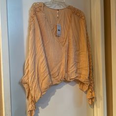 Free People Super Cute Boho Crochet Runaway Top. Features A Lined Surplice V-Neck, Crochet Lace Insets, Dolman Sleeves, And An Elasticized Waist. Cropped, Relaxed Fit. New With Tags Size: Large Ob562892 Color: Light Peach Fabric: Rayon + Modal Fall V-neck Crochet Top, Lace V-neck Top With Crochet Trim, V-neck Tops With Crochet Trim For Vacation, V-neck Crochet Lace Top, Spring V-neck Blouse With Crochet Lace, Chic V-neck Blouse With Crochet Trim, Bohemian V-neck Lace Top For Day Out, Casual V-neck Blouse With Crochet Lace, Casual Beige Lace Top, V-neck