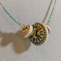 the necklace is made with beads and shells