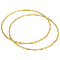 two gold colored metal bracelets on a white background