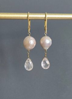 Genuine Freshwater Pearl and Pink Faceted Teardrop Rose Quartz Earrings, 24 K Gold Filled, June Birthstone, Gift for Mother, Wife, Sister. * Material *  24 K Gold Filled, natural stone. Pearls of different shapes on the right and left, respectively, chose a natural one from which the goodness of natural products came out.  Glossy ivory is attractive.  Earring size: 1.85'' (47 mm. ) from top to bottom. *Please add this store as your favorite and visit again! https://www.etsy.com/shop/GlamorousJew Wedding Gemstone Teardrop Earrings, Wedding Teardrop Gemstone Earrings, Pink Briolette Earrings For Wedding, Pink Briolette Jewelry For Wedding, Teardrop Faceted Earrings For Wedding, Briolette Faceted Wedding Earrings, Faceted Teardrop Earrings For Weddings, Wedding Briolette Faceted Earrings, Wedding Teardrop Faceted Earrings