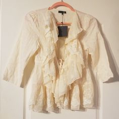 Cream Bobo Jacket With Tie Closure. 100% Cotton. Cream Fabric Has A Very Subtle Checkered Pattern. Lace Along Edges And Bottom Of Jacket. Drawstring Tie Closure With Silver Hardware. Really Beautiful. I Just Bought The Wrong Size And They Wouldn't Let Me Return It. Spring Long Sleeve Outerwear With Ruffles, Fitted Cream Outerwear With Ruffles, Spring Daywear Long Sleeve Blazer, Beige Ruffled Outerwear For Spring, Spring Long Sleeve Blazer, Cream Blazer For Spring Day Out, Spring Long Sleeve Blazer For Daywear, Spring Cream Blazer For Day Out, Cream Long Sleeve Outerwear With Ruffles